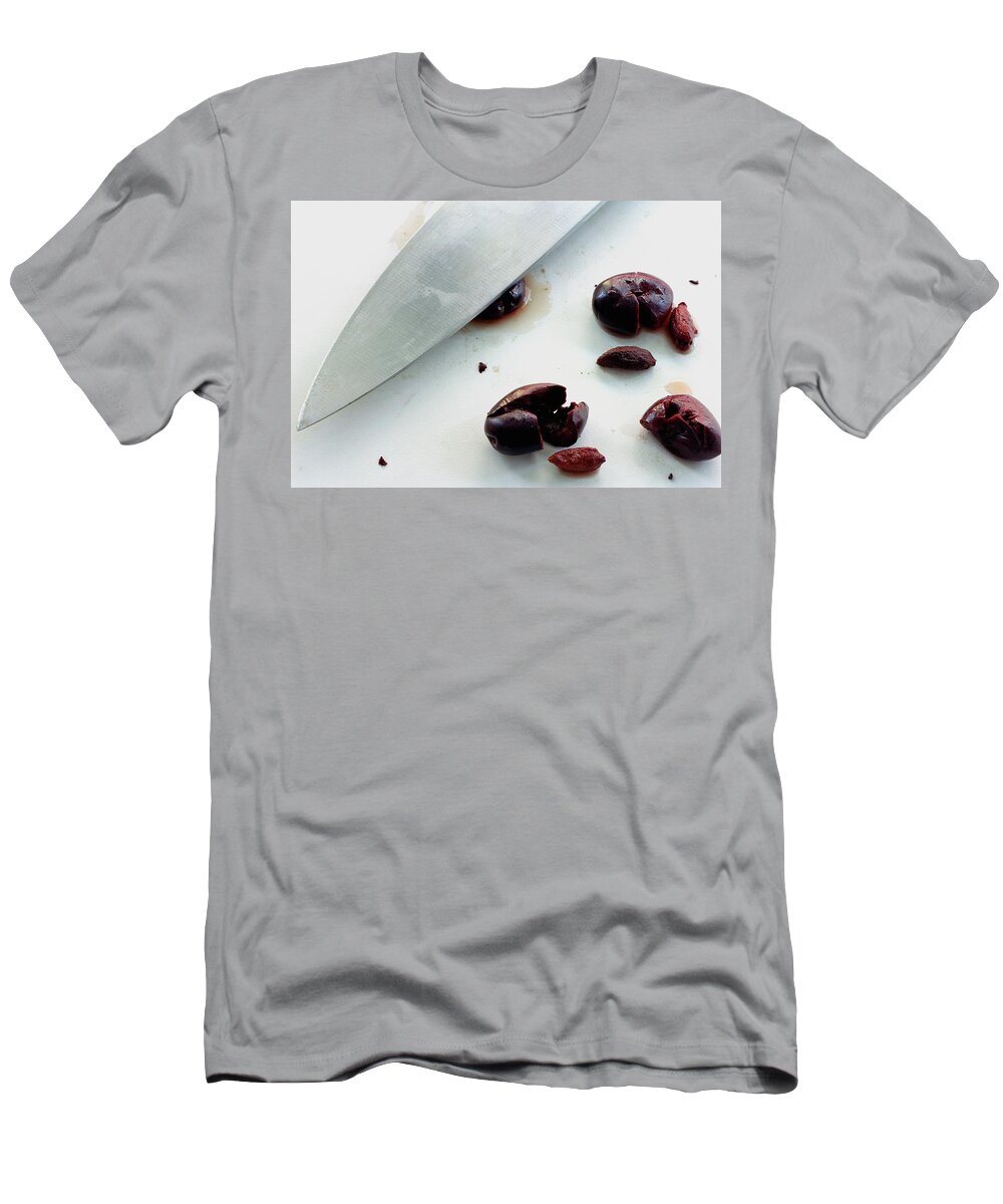 Fruits T-Shirt featuring the photograph A Sharp Knife And A Group Of Olives by Romulo Yanes