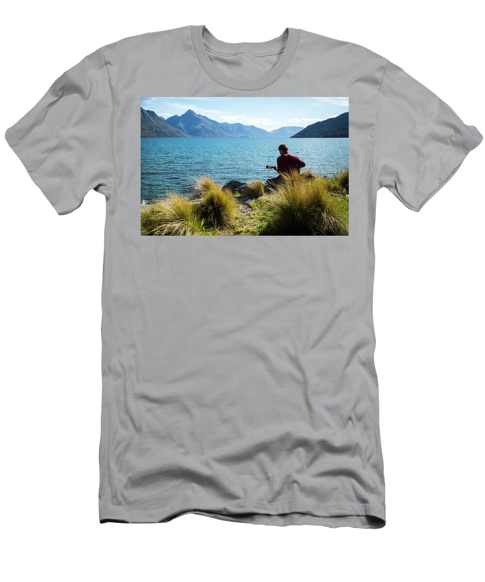 Guitar T-Shirt featuring the photograph Man Playing The Guitar Along The Side by Paul Bikis