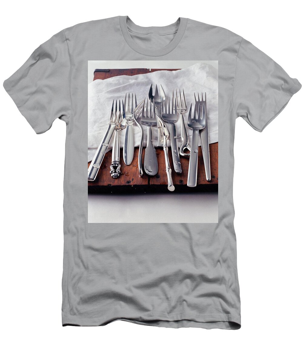 Kitchen T-Shirt featuring the photograph Various Forks On A Wooden Board by Romulo Yanes