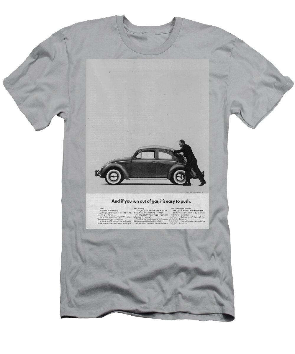 Vw Beetle T-Shirt featuring the digital art VW Beetle Advert 1962 - And if you run out of gas it's easy to push by Georgia Fowler
