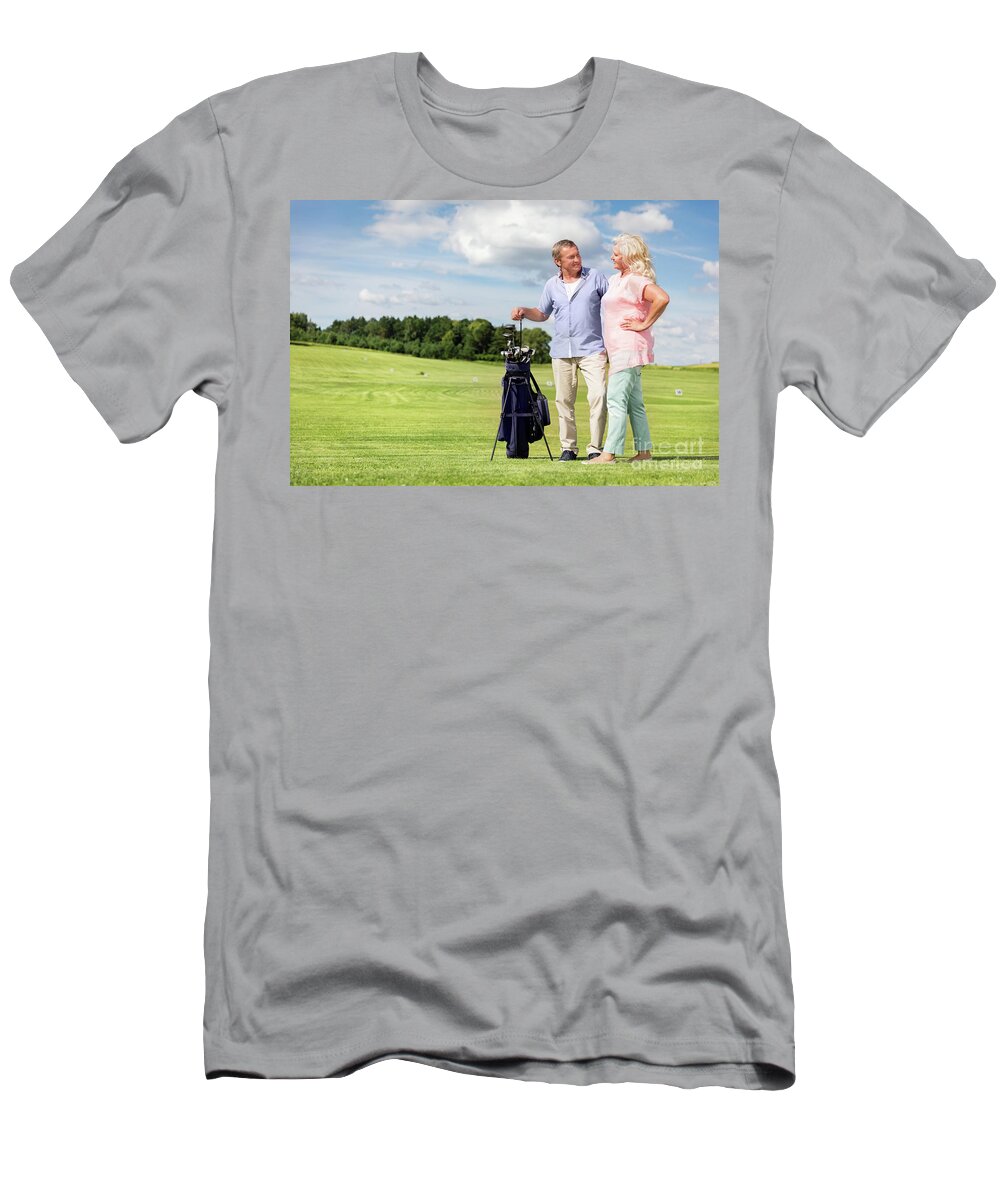 Golf T-Shirt featuring the photograph Senior couple enjoying golf game. #1 by Michal Bednarek