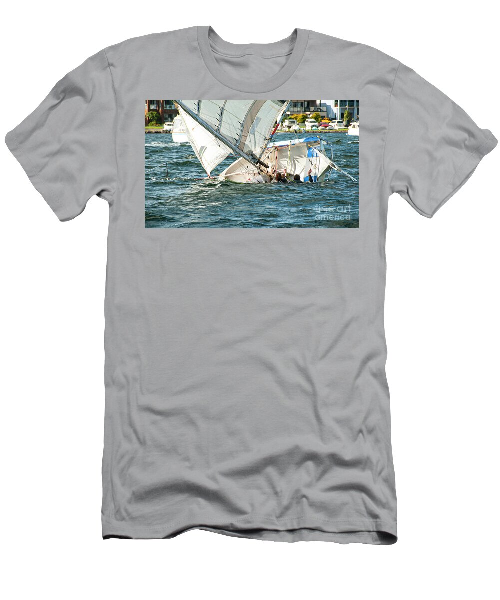 Cloud T-Shirt featuring the photograph Two children in the water climbing back into a capsized sailboat by Geoff Childs