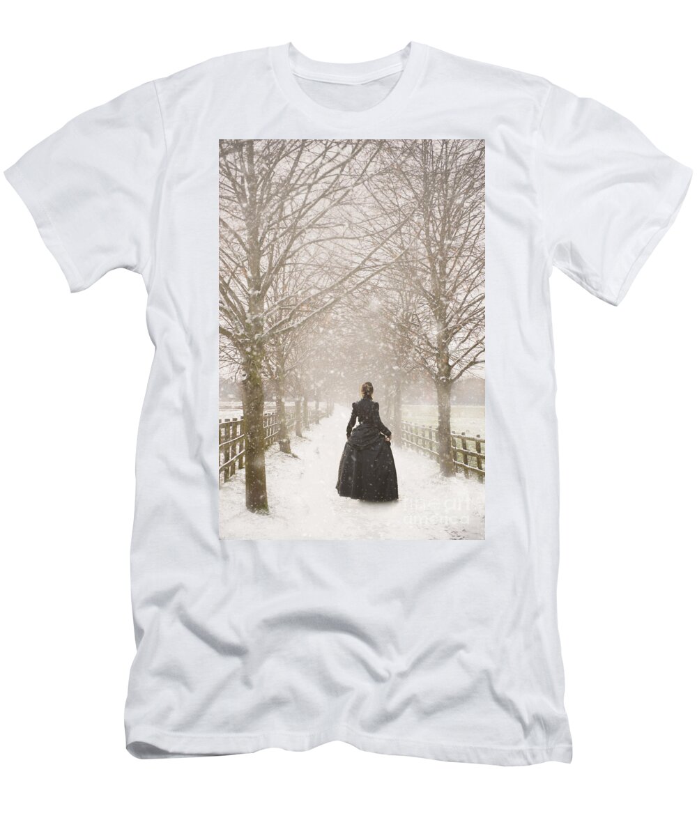Victorian T-Shirt featuring the photograph Victorian Woman Walking A Tree Lined Avenue In Snow #1 by Lee Avison