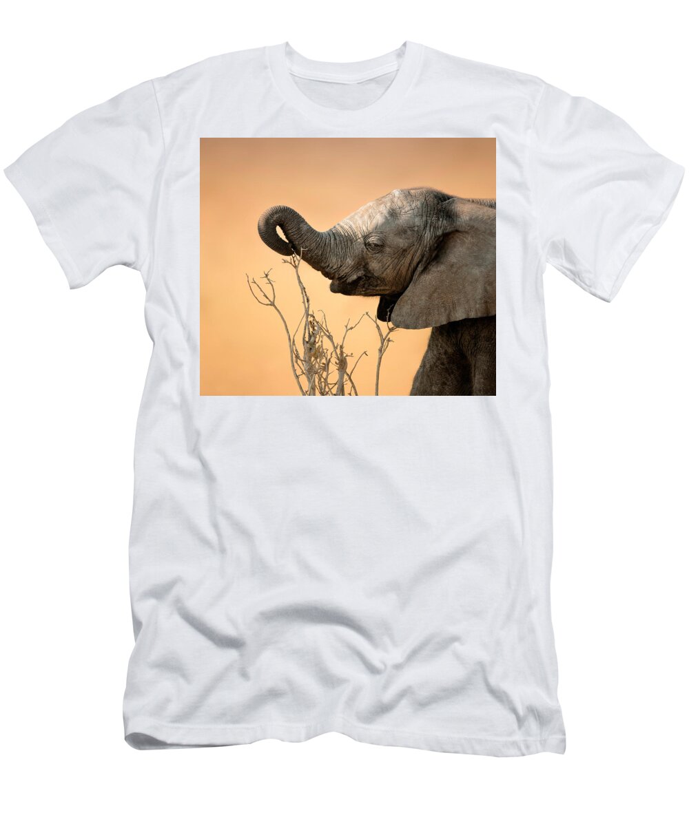 Elephant T-Shirt featuring the photograph Baby elephant reaching for branch by Johan Swanepoel