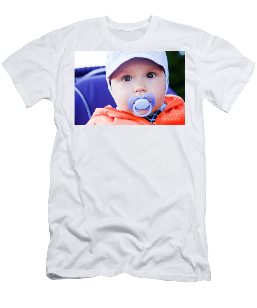 Child T-Shirt featuring the photograph Young baby boy with a dummy in his mouth outdoors by Michal Bednarek