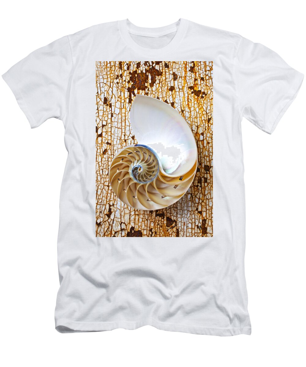 Nautilus Shell T-Shirt featuring the photograph Nautilus shell on rusty table by Garry Gay