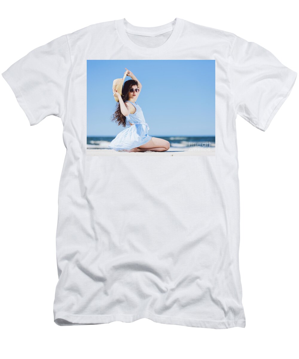 Woman T-Shirt featuring the photograph Pretty girl sitting on a sandy beach by the blue sea. by Michal Bednarek