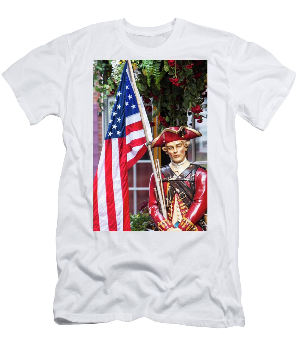 Boston T-Shirt featuring the photograph Red Coat holding the American flag by Jason Hughes