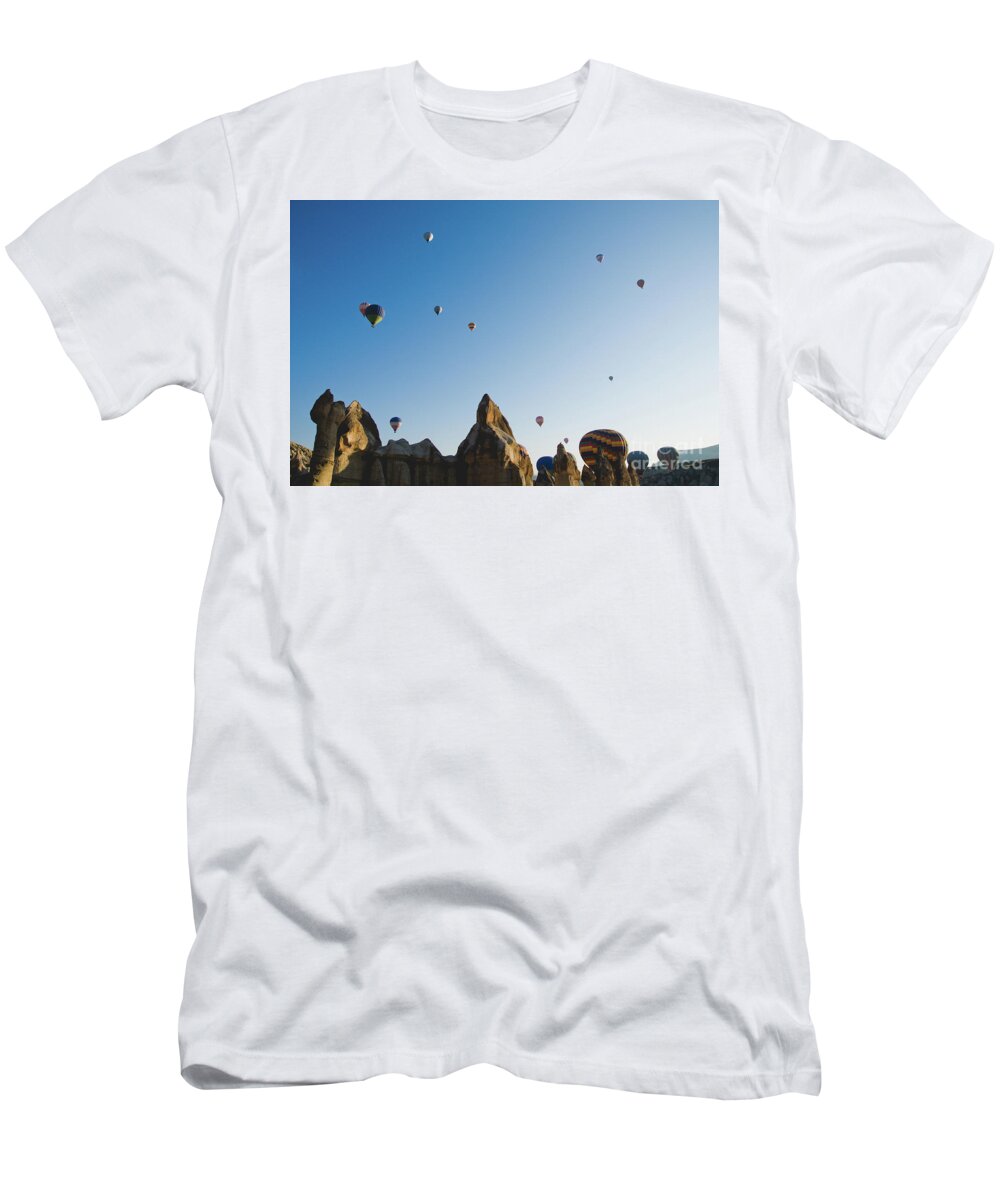 Adventure T-Shirt featuring the photograph Colorful balloons flying over mountains and with blue sky #5 by Joaquin Corbalan