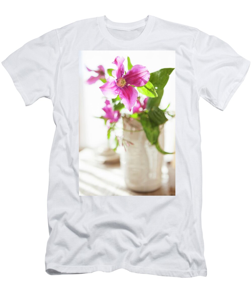 Ip_11309965 T-Shirt featuring the photograph Purple Clematis In White Ceramic Vase by Anneliese Kompatscher