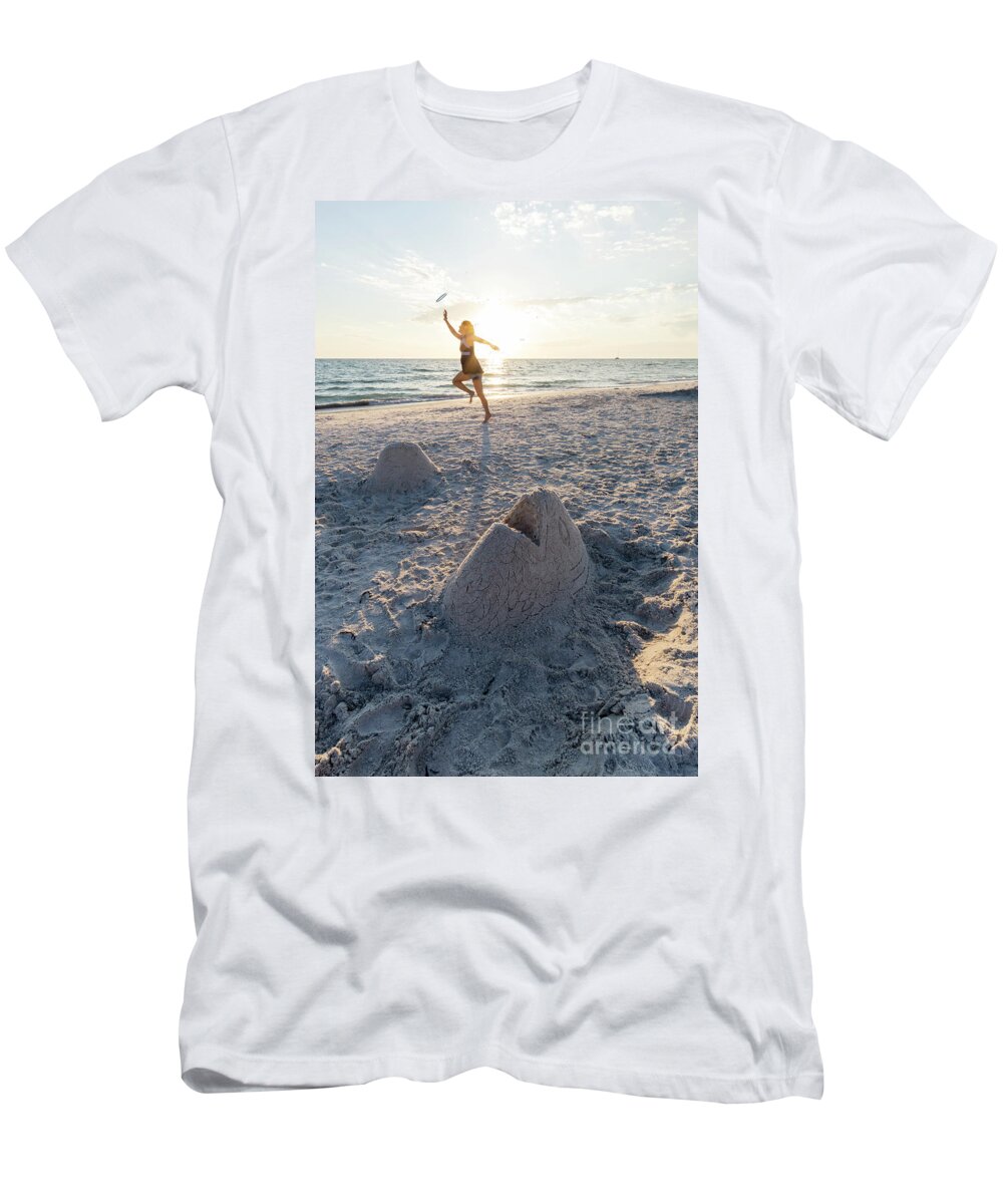 Anna Maria Island T-Shirt featuring the photograph A woman catches a flying disk near a sand sculpture of a fish he by William Kuta
