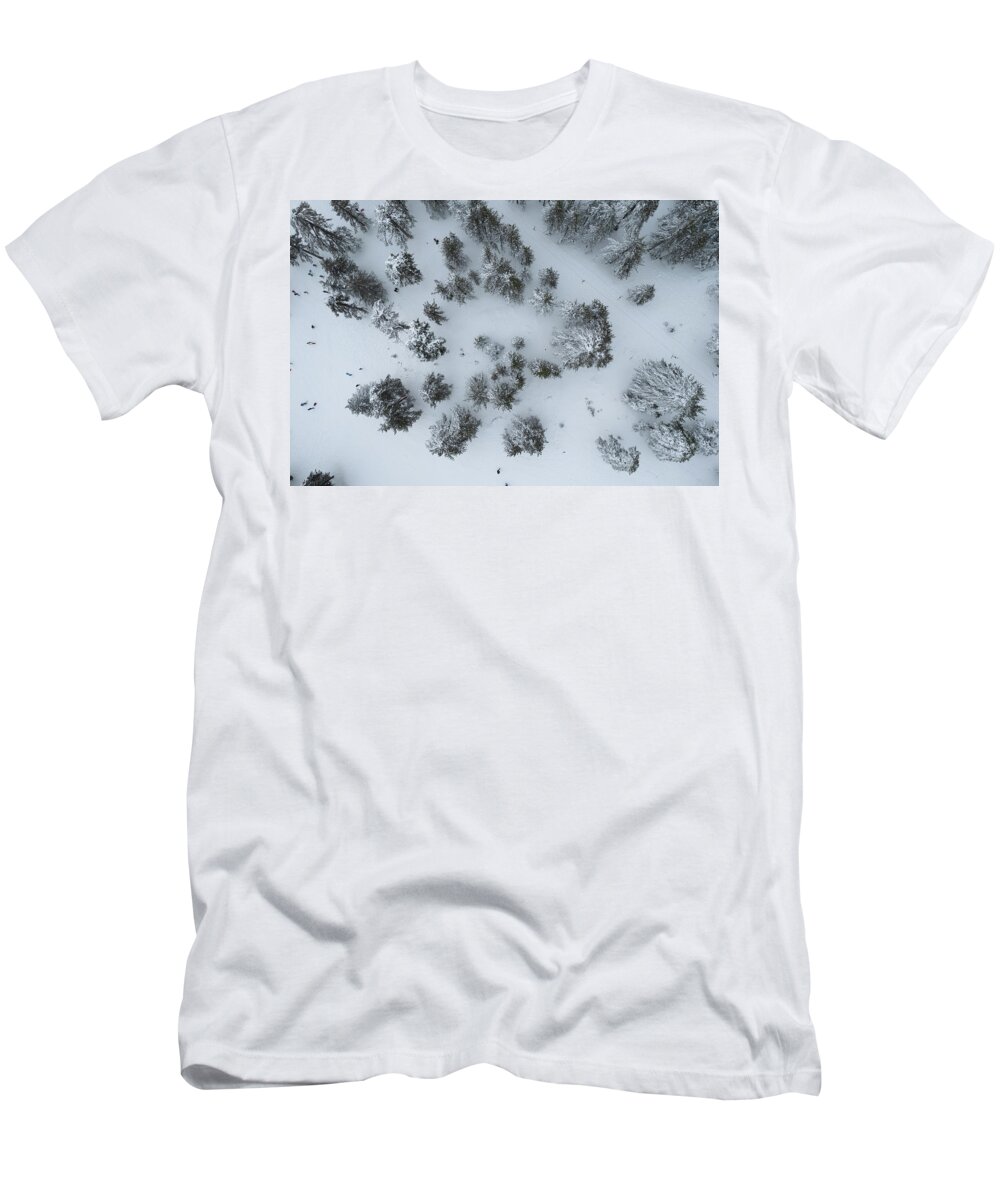 Winter T-Shirt featuring the photograph Drone aerial scenery of mountain snowy forest and people playing in snow. Wintertime season by Michalakis Ppalis