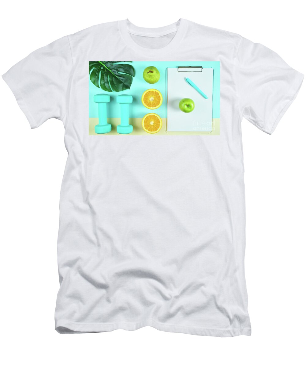 Health T-Shirt featuring the photograph Health and fitness concept on modern colorful background. by Milleflore Images