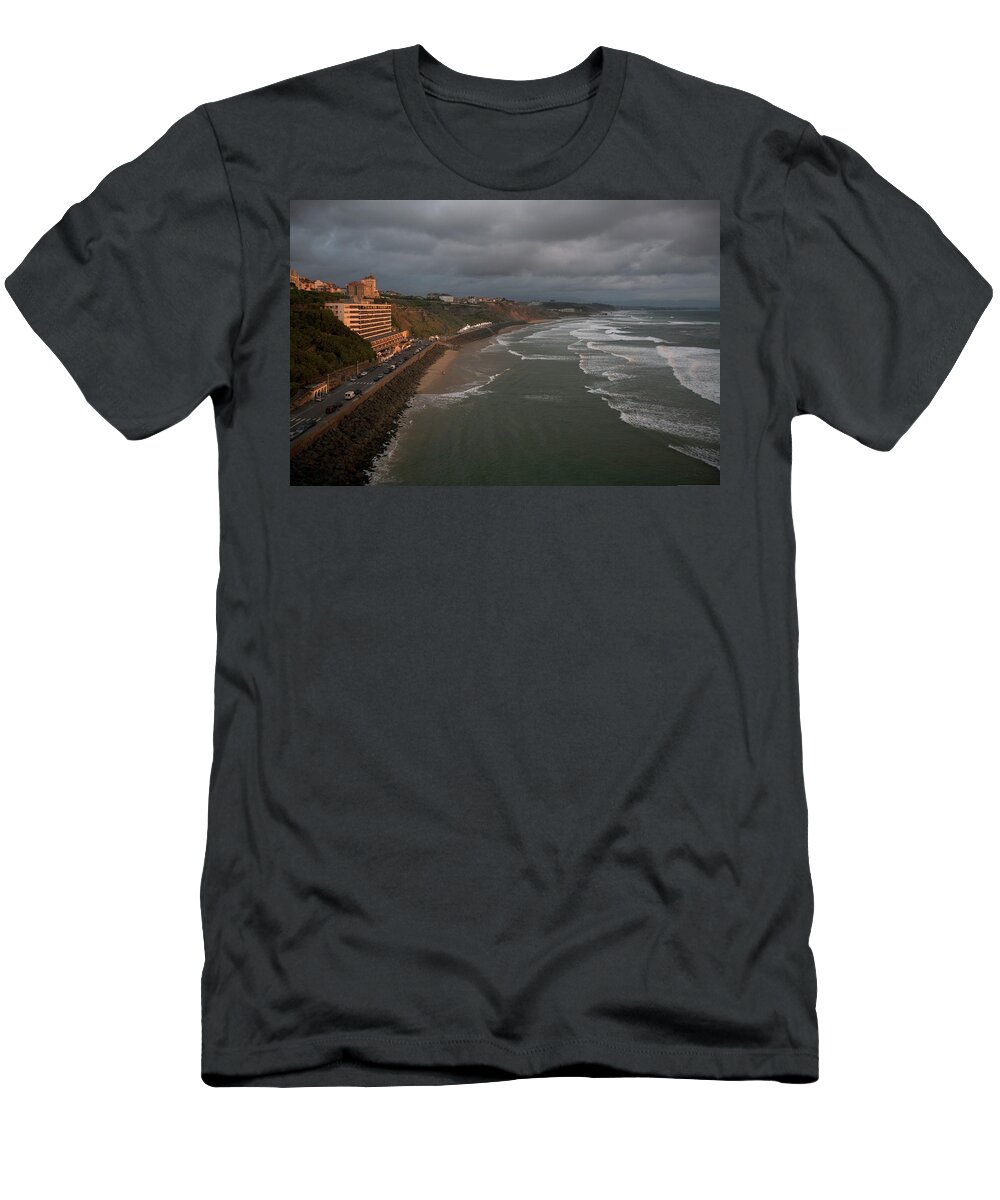 Atlantic Ocean T-Shirt featuring the photograph A Hotel Lit By A Pinkish Orange Sunset by Aaron Black