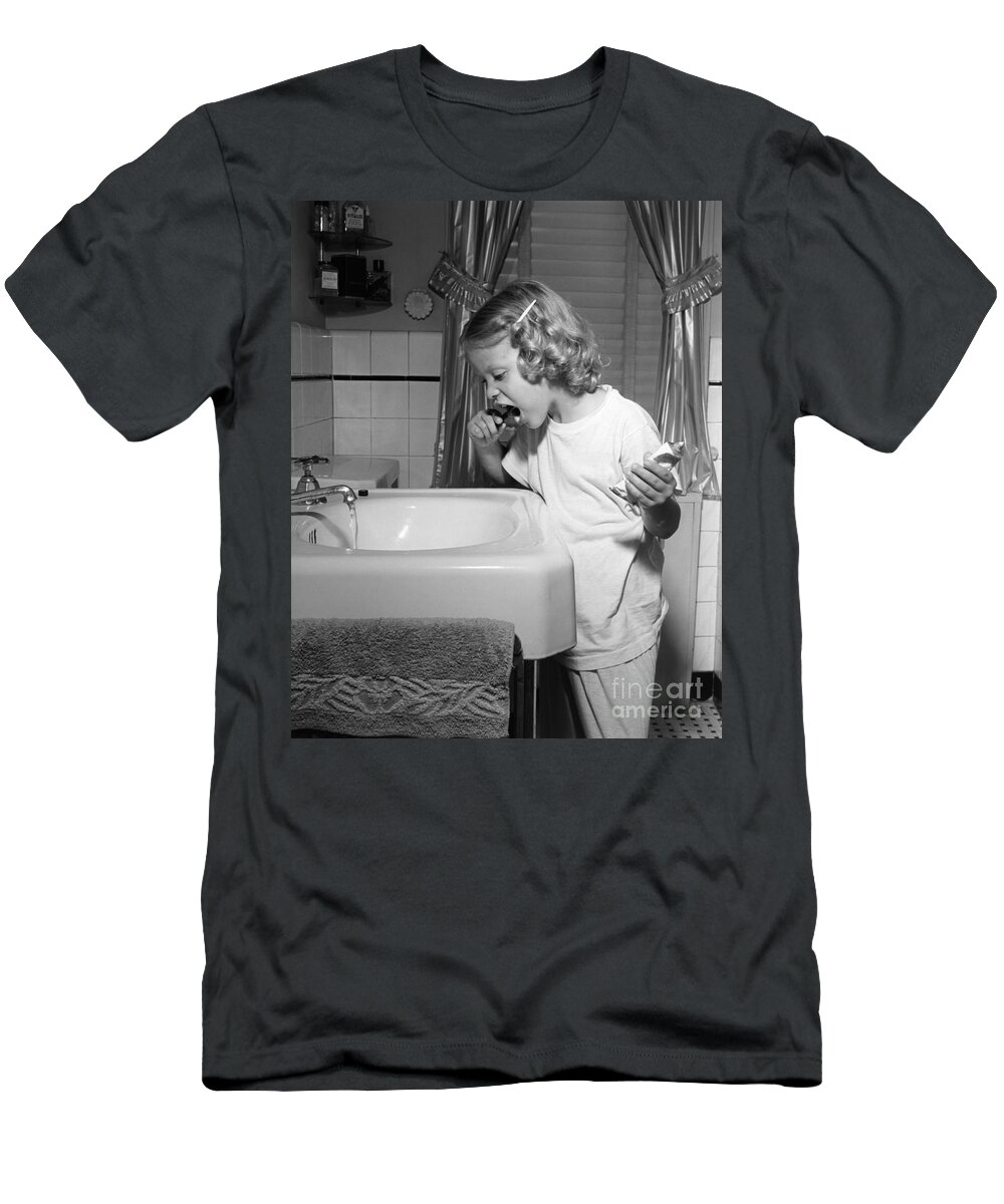 1950s T-Shirt featuring the photograph Girl Brushing Her Teeth, C.1950s by E. Hibbs/ClassicStock