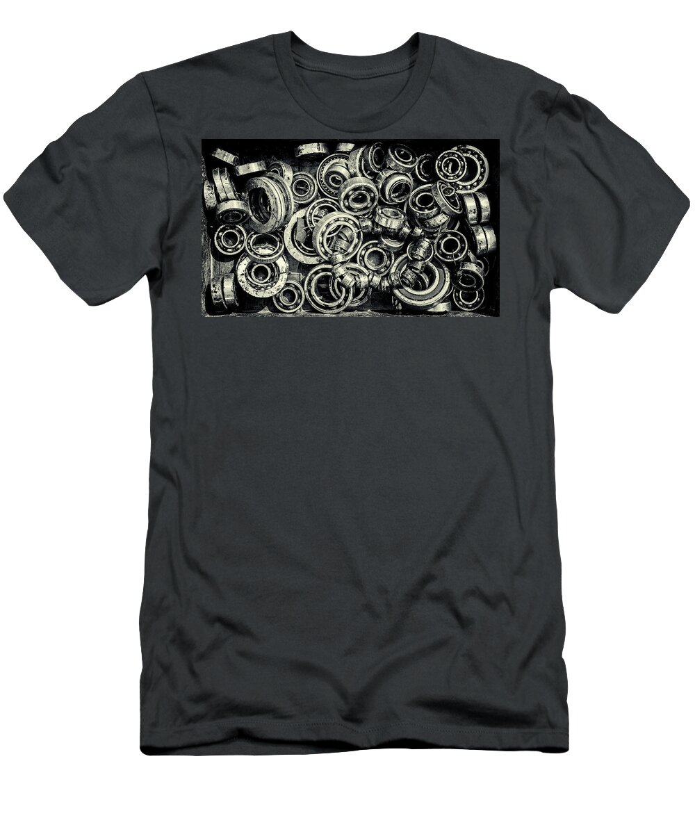 Mechanism T-Shirt featuring the photograph Pile of Old Rusty Ball Bearing Wheels by John Williams