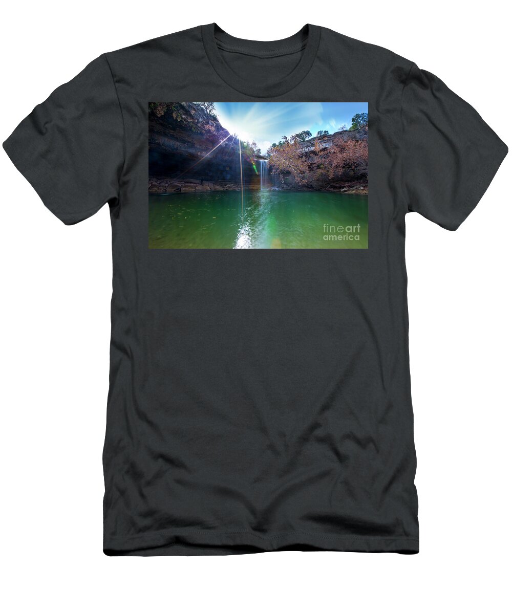 Hamilton Pool Nature Preserve T-Shirt featuring the photograph Sun rays shimmer through the cliffs at Hamilton Pool Nature Preserve as a beautiful 50-foot waterfall cascades down the pool by Dan Herron