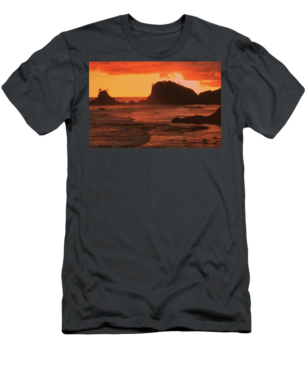 Sunset On Rocky Coast T-Shirt featuring the photograph Sunset on a rocky coast by PhotographyAssociates
