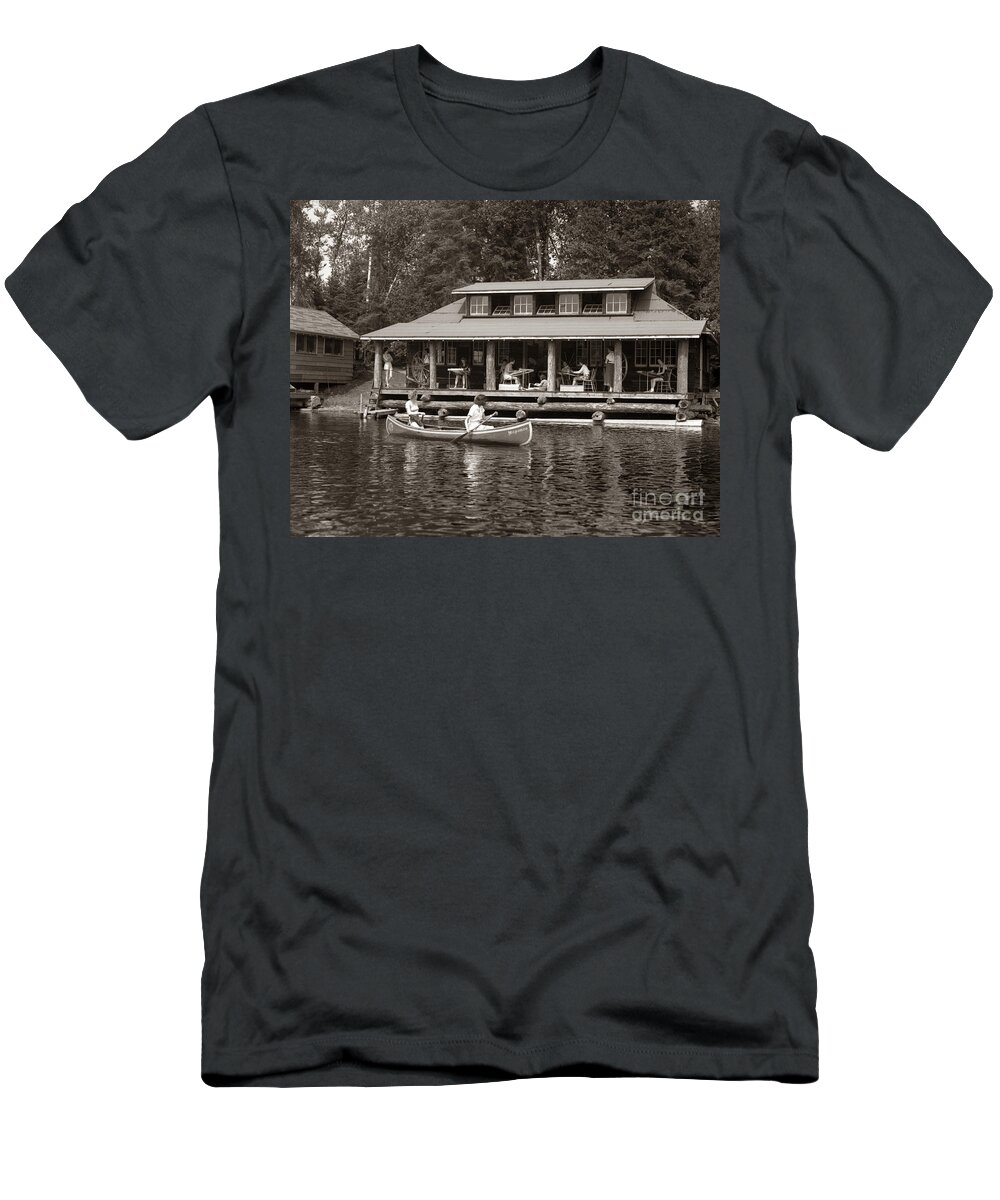 1950s T-Shirt featuring the photograph Women Canoe Past A Cabin, C.1950s by H. Armstrong Roberts/ClassicStock