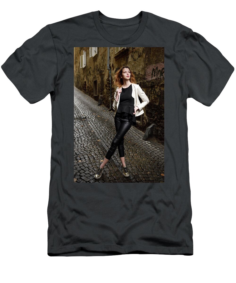 Young T-Shirt featuring the photograph Young attractive woman standing in the wet cobblestone Reber all by Reimar Gaertner