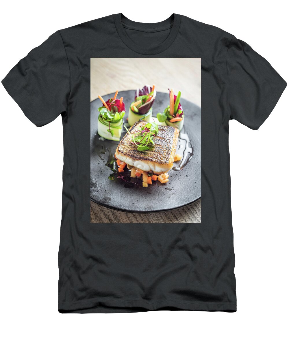 Ip_12435325 T-Shirt featuring the photograph Pan Fried Sea Bass Fish Fillet On A Bed Of Diced Sauteed Vegetables And Pretty Vegetable Rolls by Giulia Verdinelli Photography