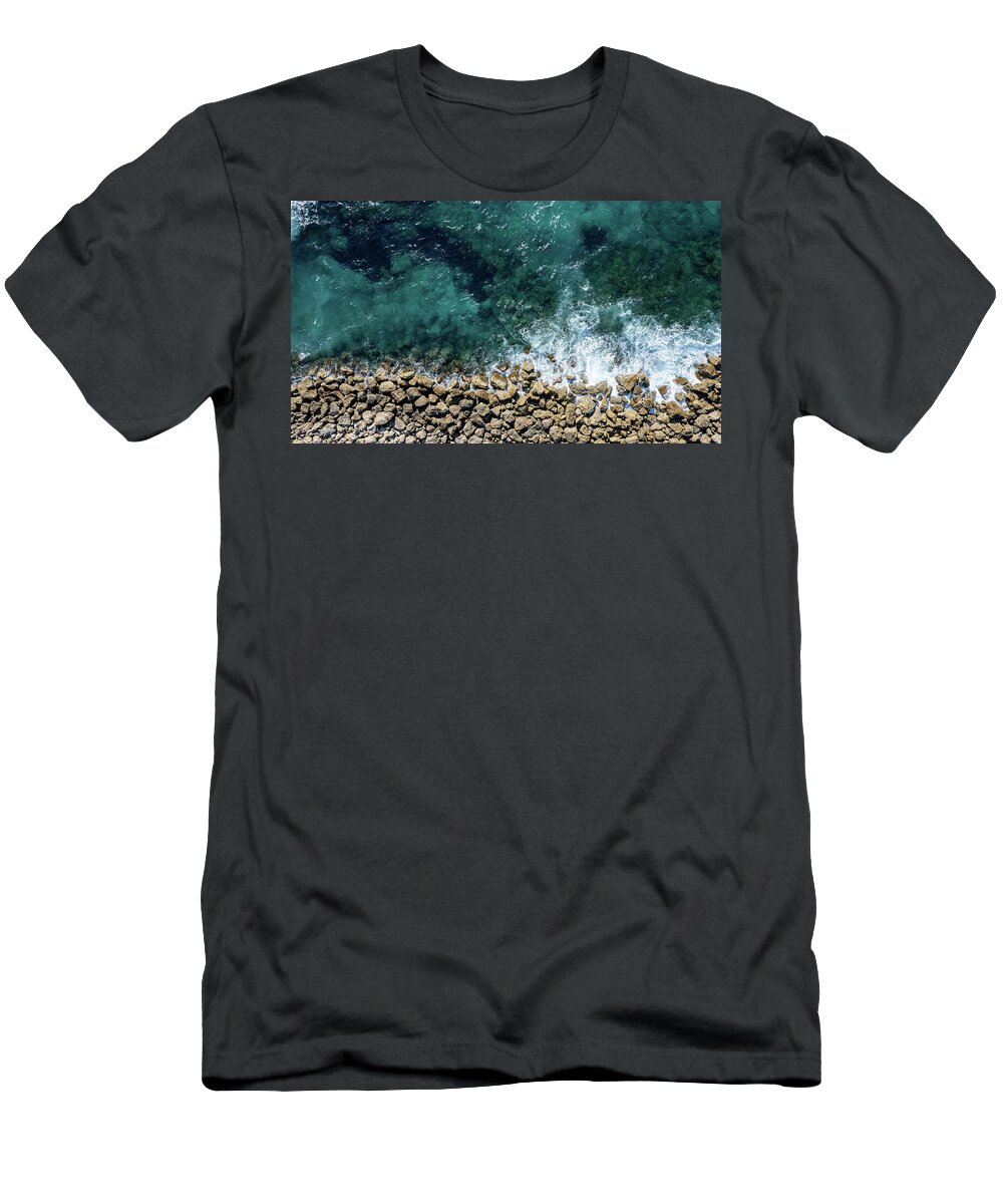 Seascape T-Shirt featuring the photograph Aerial view from flying drone of crystal blue ocean water and sea wall. by Michalakis Ppalis