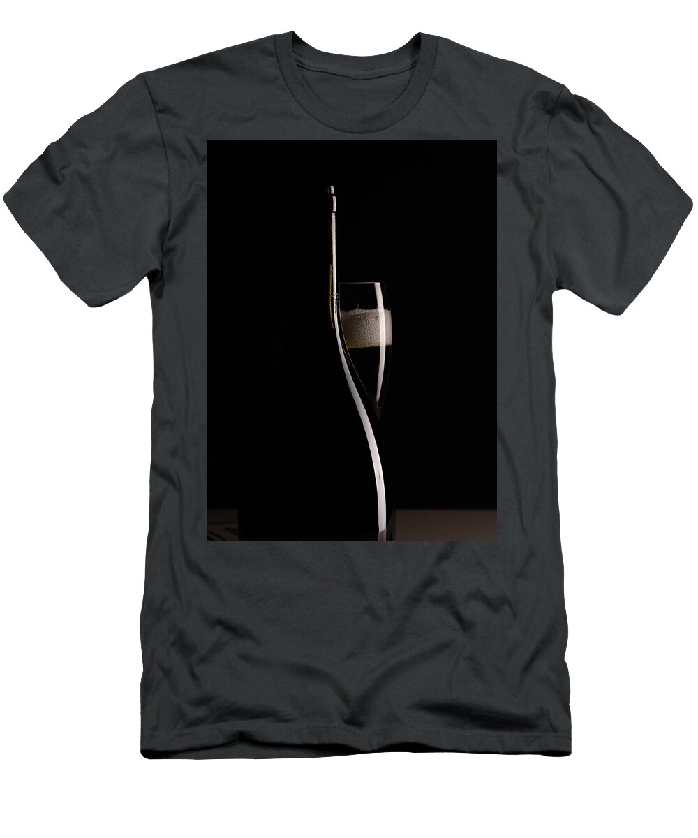 Red Wine T-Shirt featuring the photograph Red sparking wine on a wineglass and black wine bottle. #3 by Michalakis Ppalis