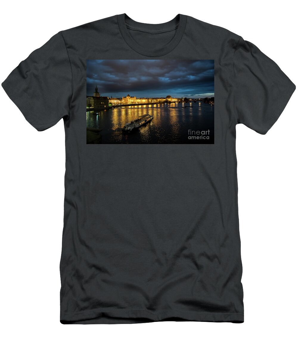 Architecture T-Shirt featuring the photograph Illuminated Moldova River With Ship And Buildings In The Night In Prague In The Czech Republic by Andreas Berthold
