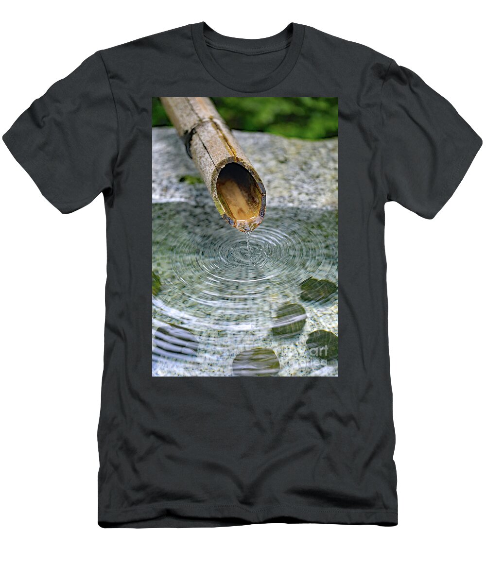 Water Fountain; Fountain; Japanese Fountain; Japanese Garden; Zen; Water; Drip; Droplets; Bamboo; Pool; Stone; Pebbles; Green; T-Shirt featuring the photograph In a Japanese Garden by Tina Uihlein