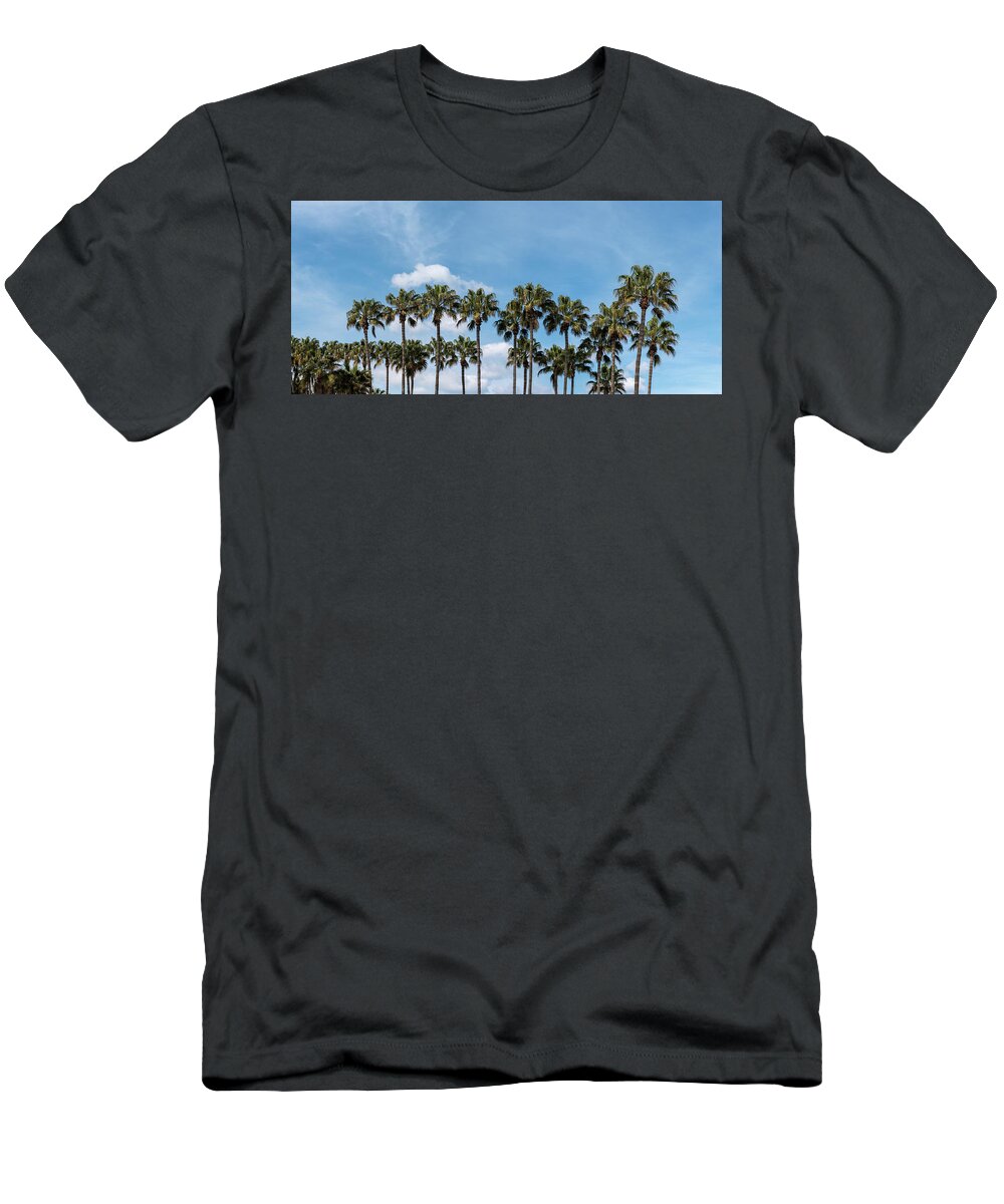 Palm Tree T-Shirt featuring the photograph Palm trees against blue sky, at tropical coast by Michalakis Ppalis