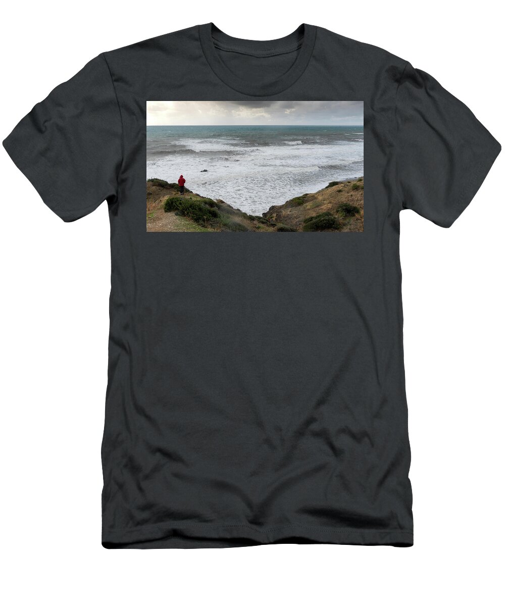 Seascape T-Shirt featuring the photograph Person standing the edge of a cliff end enjoying th by Michalakis Ppalis