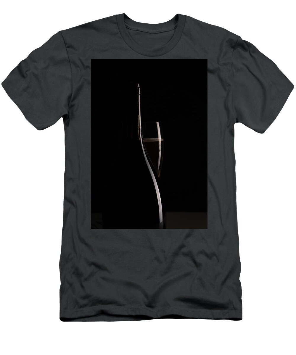 Red Wine T-Shirt featuring the photograph Red sparking wine on a wineglass and black wine bottle. by Michalakis Ppalis