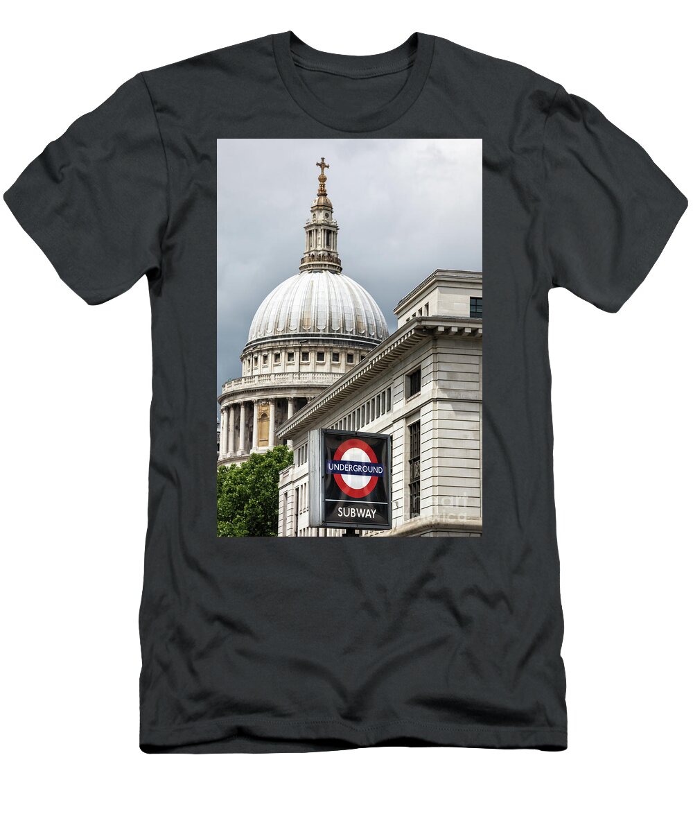 Underground T-Shirt featuring the photograph The dome of St Paul's cathedral behind a London underground roundel sign. Focus on the iconic red, white and blue tube logo in foreground. by Jane Rix