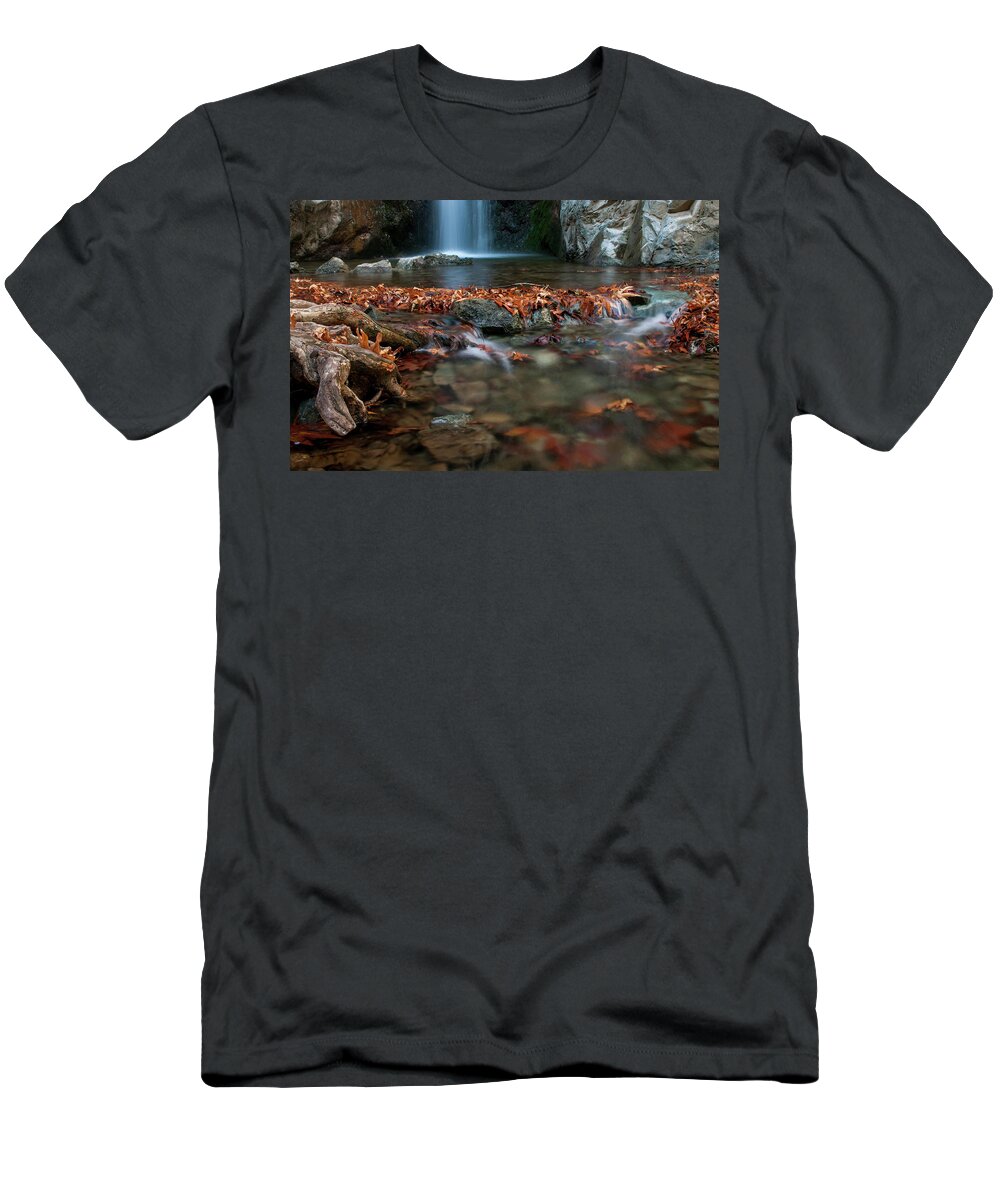 Troodos T-Shirt featuring the photograph Waterfall and river flowing with maple leaves on the rocks on the river in Autumn by Michalakis Ppalis