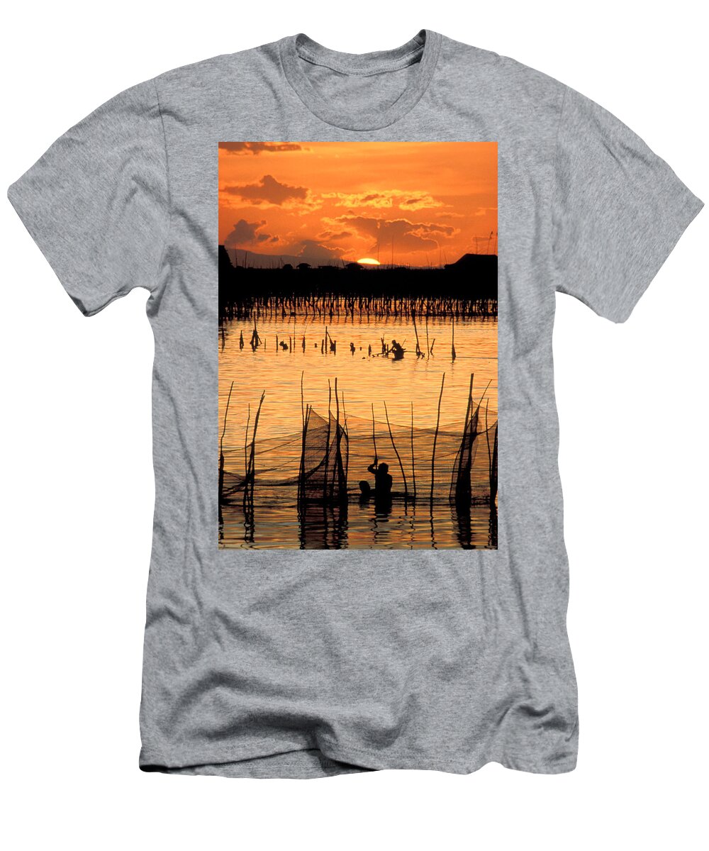 Vertical; Outdoors; Sunset; Incidental People; Silhouette; Non Urban Scene; Tranquility; Sea; Fishing; Manila; Philippines; Wading; Fishing Industry; Fishing Net T-Shirt featuring the photograph Philippines Manila Fishing by Anonymous