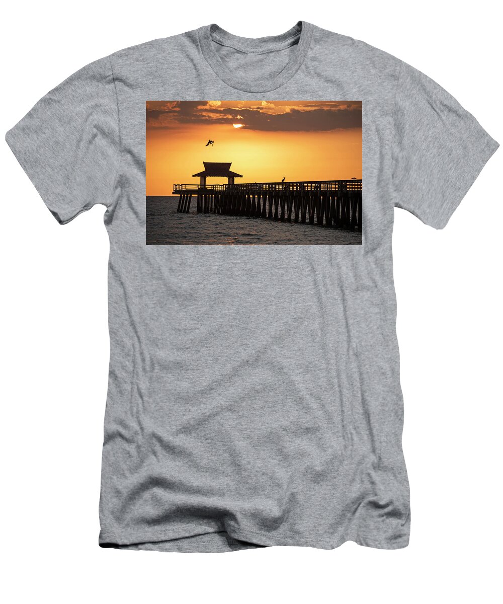 Naples T-Shirt featuring the photograph A pelican dive-bomb at the Naples Pier Naples FL by Toby McGuire