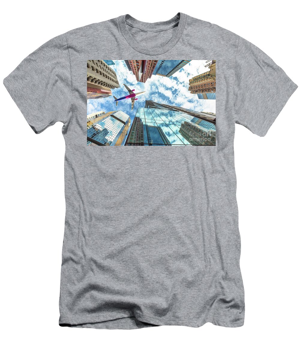 Hong Kong T-Shirt featuring the photograph Airplane flying over skyscrapers by Benny Marty