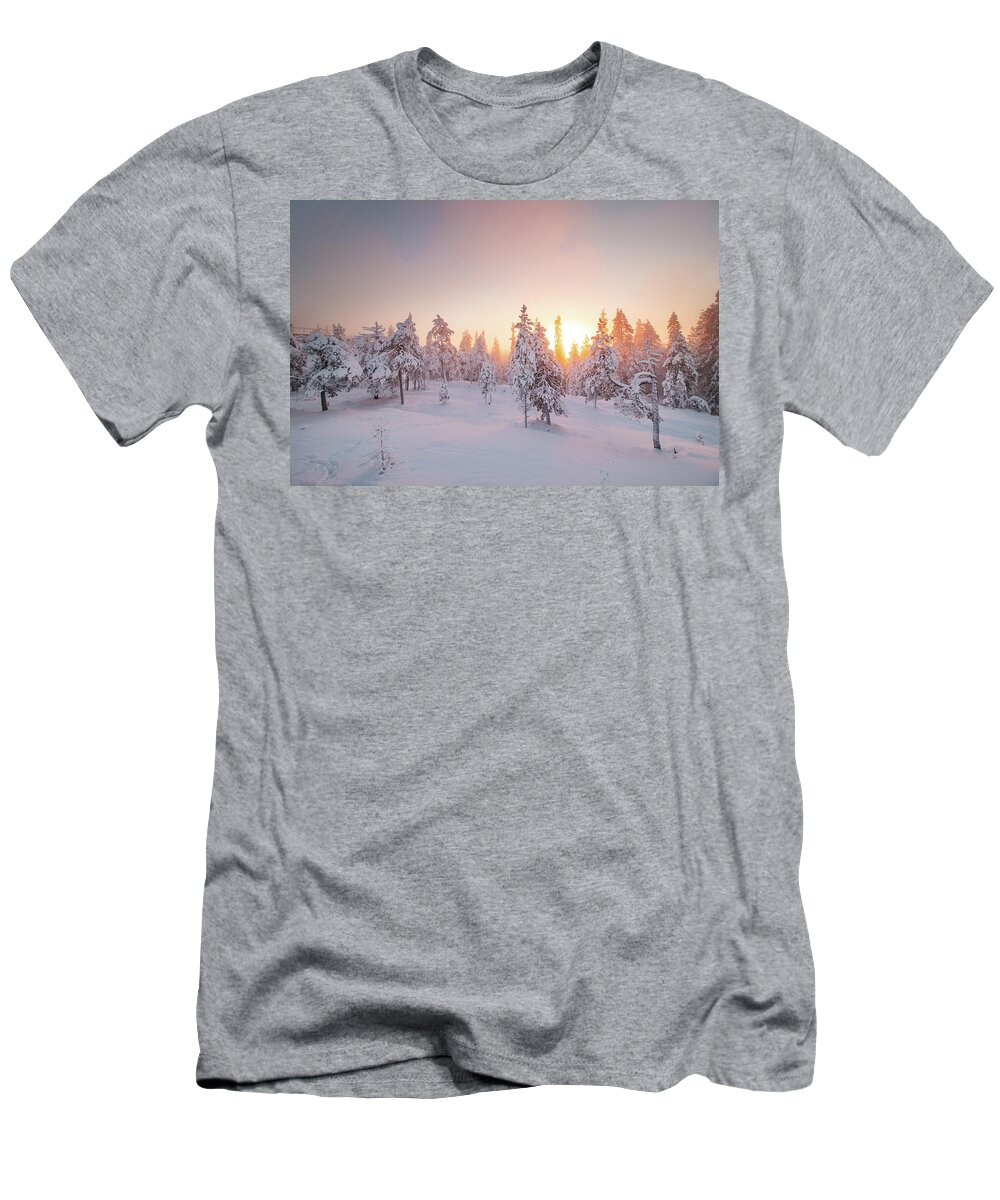 Rovaniemi T-Shirt featuring the photograph Orange rays of the sun illuminate the frosty and snowy Finnish scenery #1 by Vaclav Sonnek
