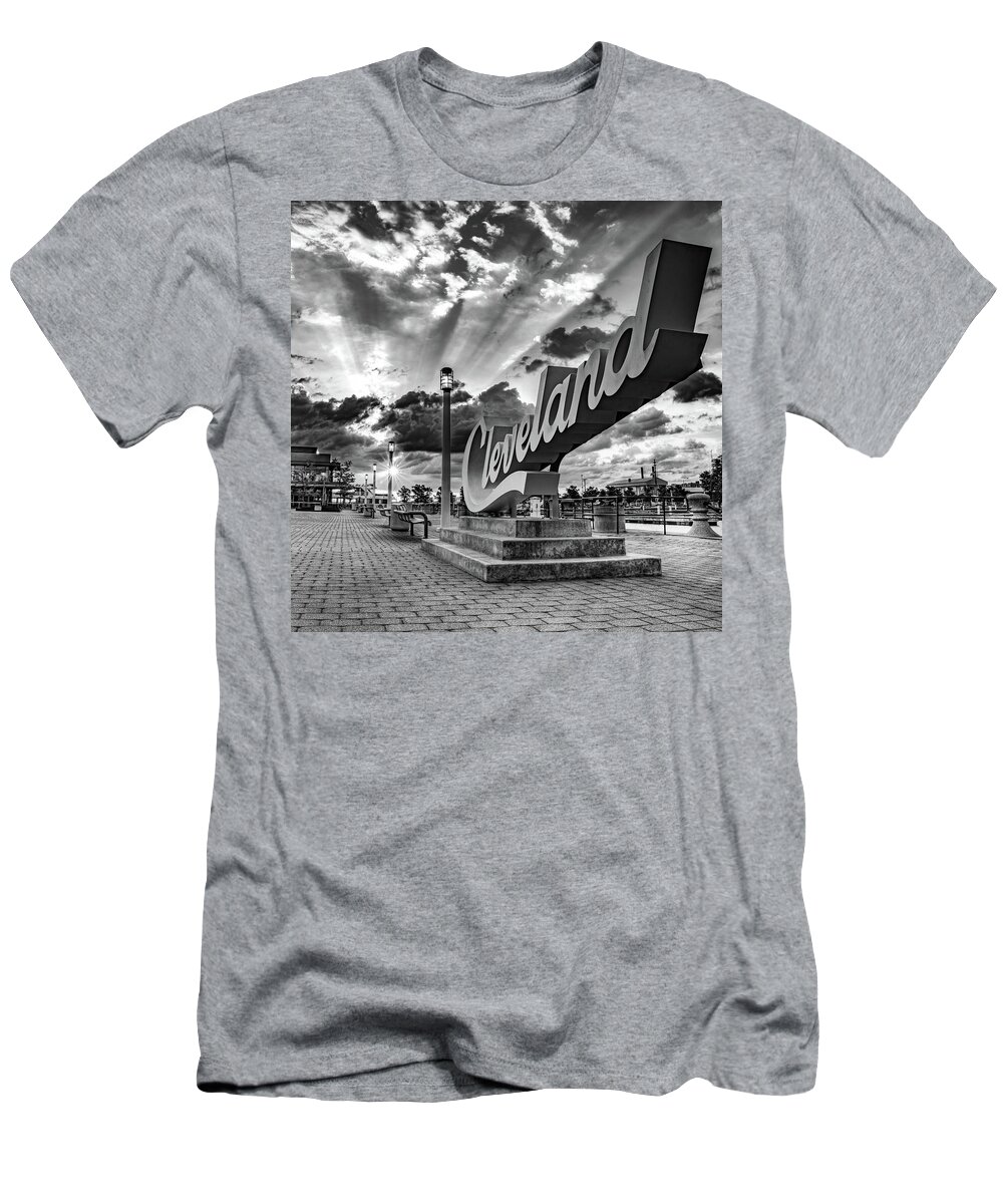 Cleveland Sculpture T-Shirt featuring the photograph Rays of Light Over The Cleveland Script Sign on North Coast Harbor - Black and White by Gregory Ballos