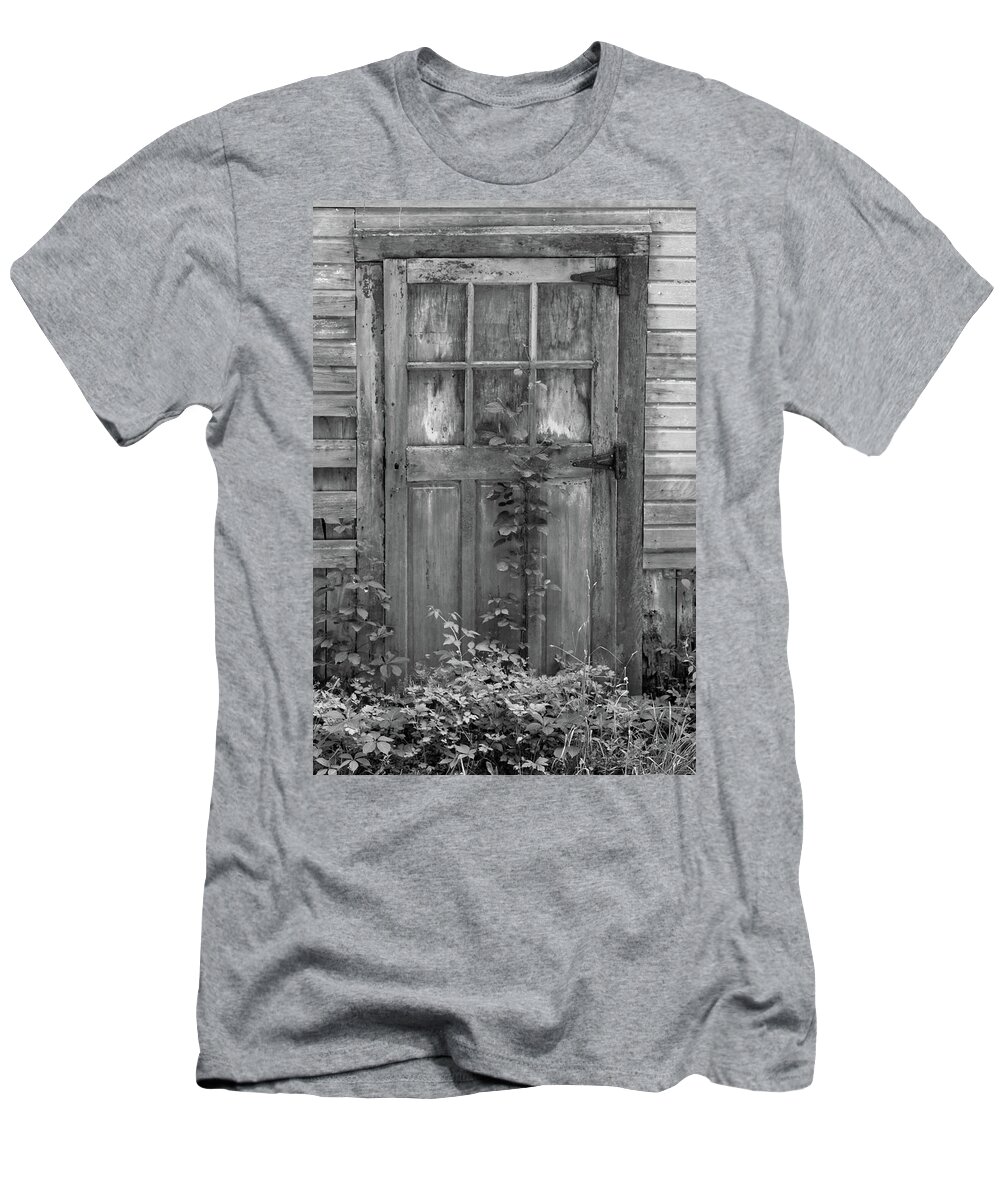 Black And White Barn T-Shirt featuring the photograph Weathered Wood Barn Door with Vine by David Letts