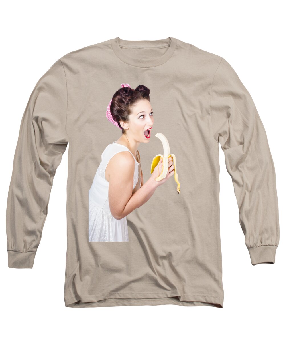 Fruit Long Sleeve T-Shirt featuring the photograph Pin-up woman eating fruit on studio background by Jorgo Photography