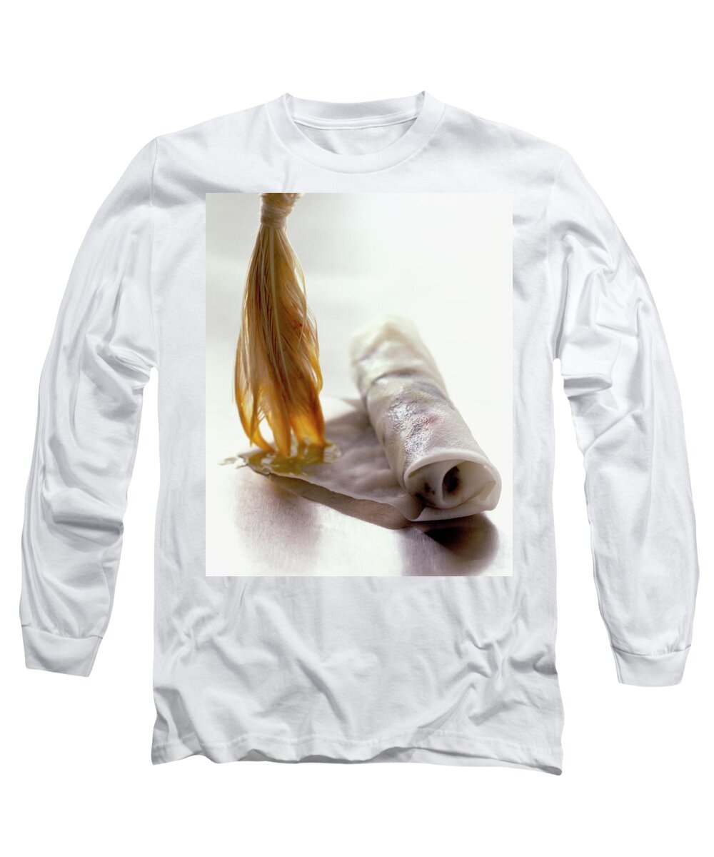 Cooking Long Sleeve T-Shirt featuring the photograph An Egg Roll by Romulo Yanes