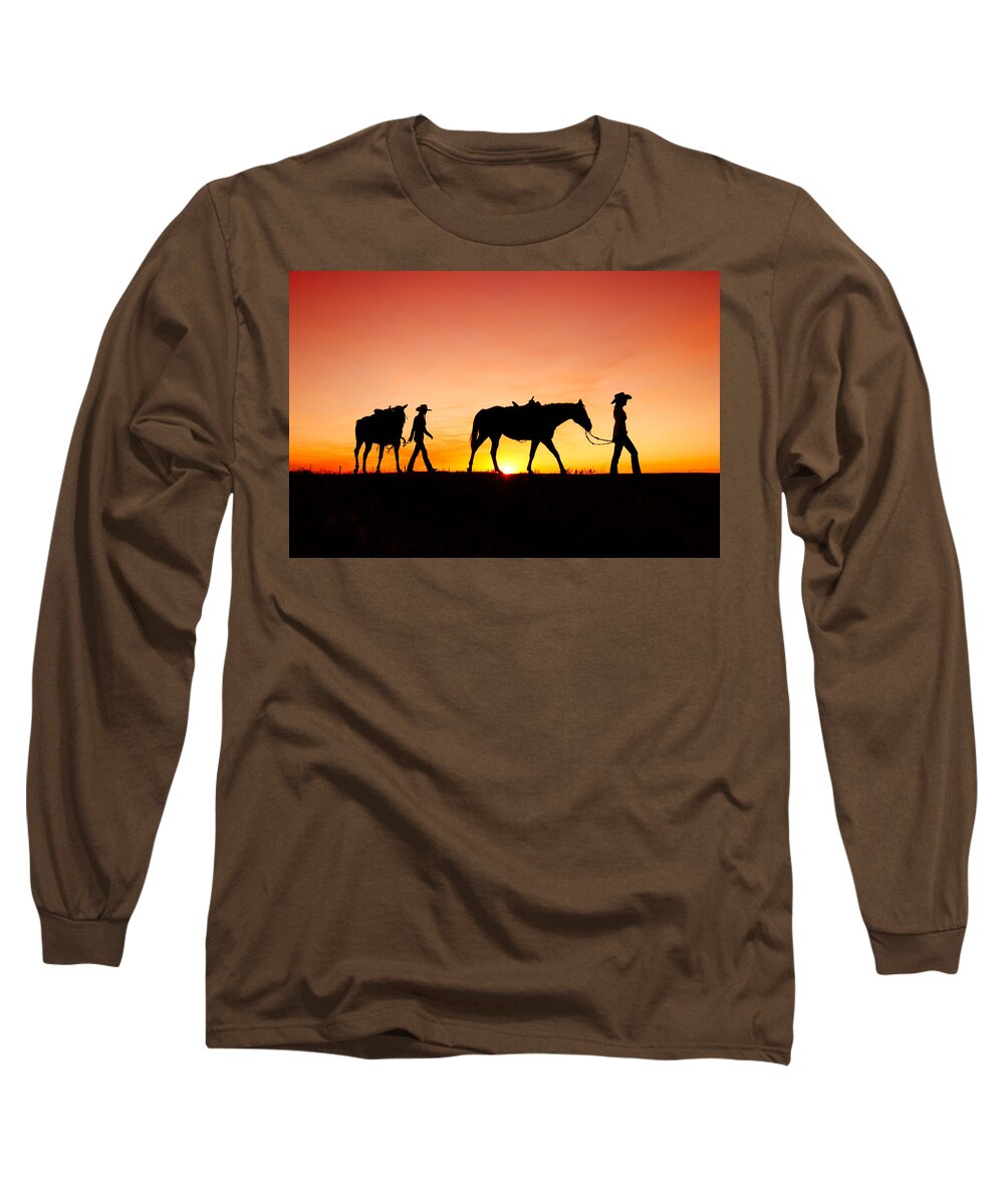 Cowgirls Silhouette Horses Sunset Sunrise Twilight Horizon Landscape Beautiful Sexy Sky Women Two Pair Girls Cowboys Rural Ranch Countryside Havre Montana Country Evening Saddle Outdoors Beauty Nature Sun Sunlight Orange American West Side View Yellow Dusk Dawn Leading Harness Halter Walking Agriculture Guest Ranch Recreation Femininity Young Feminine Legs Bright Back Lit Horizon Over Land Western West Great Plains Equine Quarter Horse Best Long Sleeve T-Shirt featuring the photograph Off to the Barn by Todd Klassy