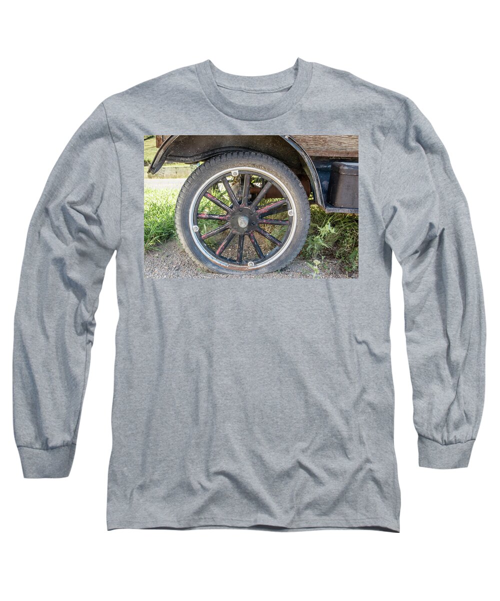 Rocky Mountain Long Sleeve T-Shirt featuring the photograph Old Truck Tire in Rural Rocky Mountain Town by Peter Ciro