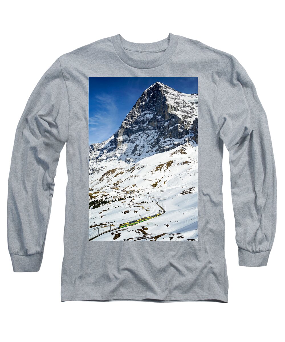 Lauterbrunnen Long Sleeve T-Shirt featuring the photograph A lonely train passing by the Eiger's North Face in Switzerland on a sunny spring day. by George Afostovremea
