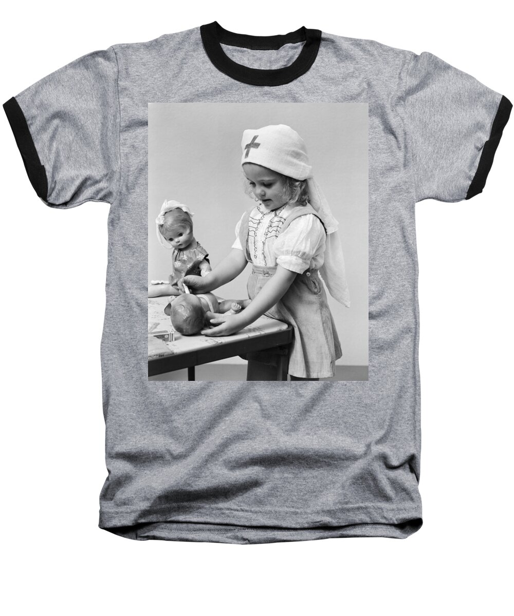 1940s Baseball T-Shirt featuring the photograph Child Playing Doctor With Dolls, C.1940s by H. Armstrong Roberts/ClassicStock