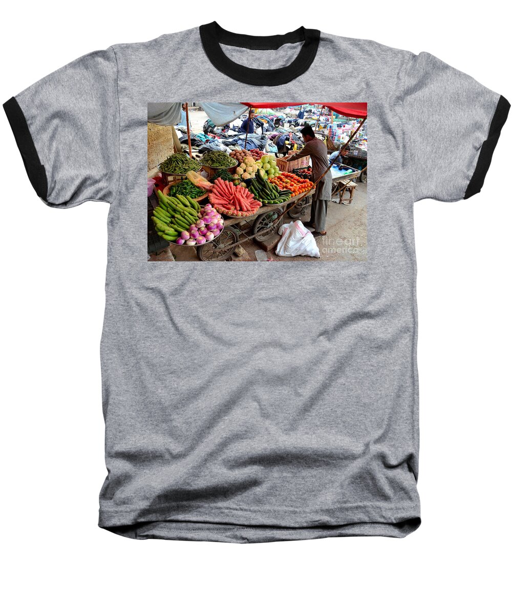 Fruits Baseball T-Shirt featuring the photograph Fruit and vegetable seller tends to his cart outside Empress Market Karachi Pakistan by Imran Ahmed