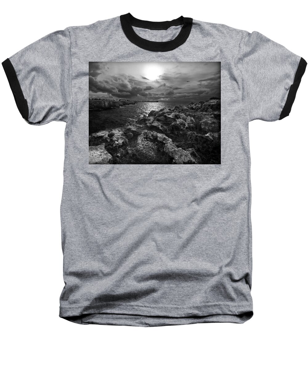 Background Baseball T-Shirt featuring the photograph Blank and white stormy mediterranean sunrise in contrast with black rocks and cliffs in Menorca by Pedro Cardona Llambias