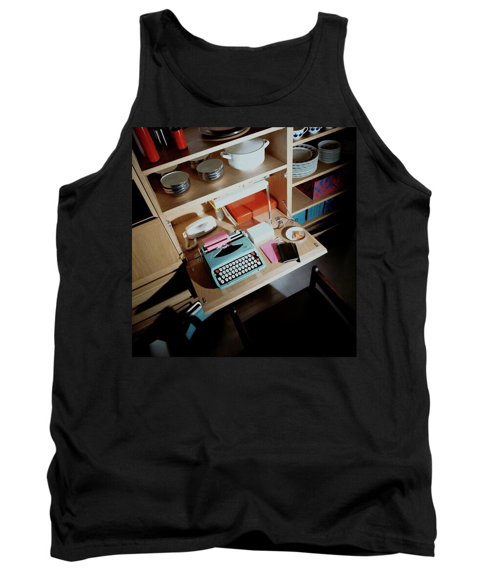 Indoors Tank Top featuring the photograph A Cupboard With A Blue Typewriter by Ernst Beadle