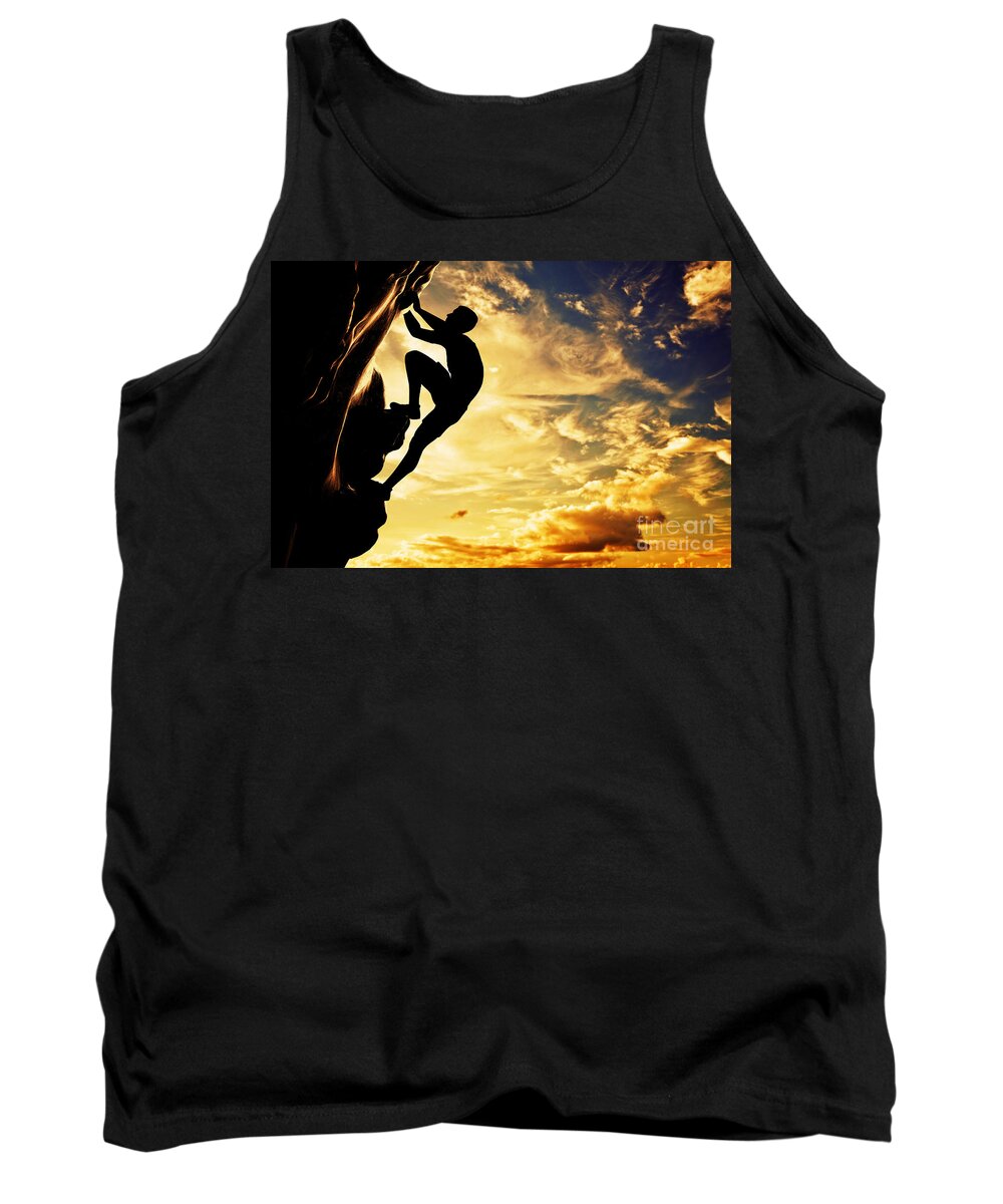 Climb Tank Top featuring the photograph A silhouette of man free climbing on rock mountain at sunset by Michal Bednarek